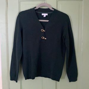 Green V-neck sweater with gold clasp details
